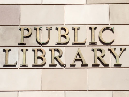 "Public Library" sign on the exterior of a building.