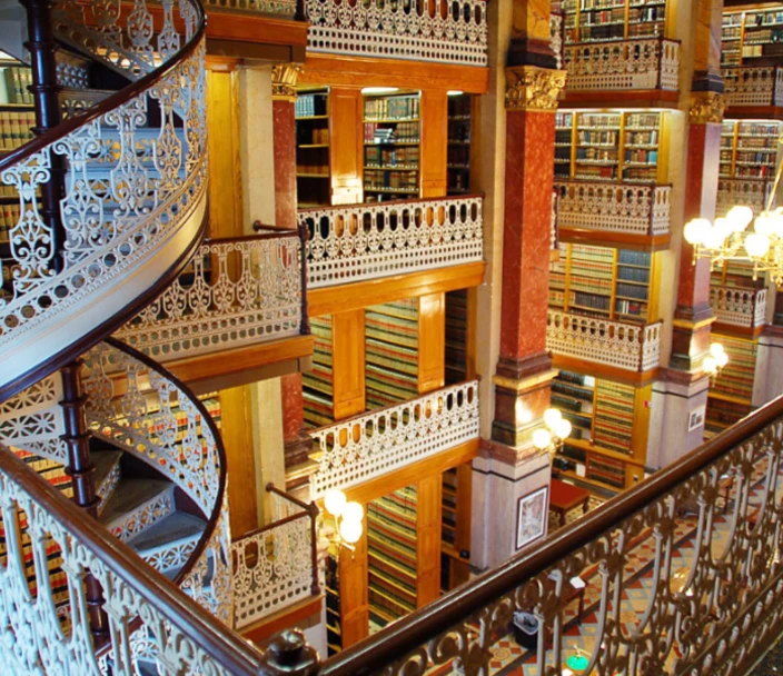 Interior of the Law Library showing spiral staircase and tiers containing bookshelves.