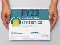 Hands holding a print copy of the Public Library Annual Statistics publication.