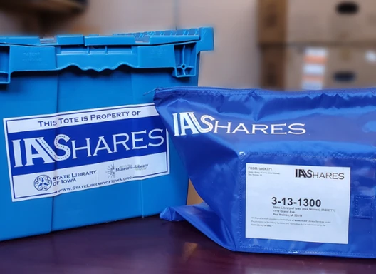 Image of official IA Shares blue bag and tote.