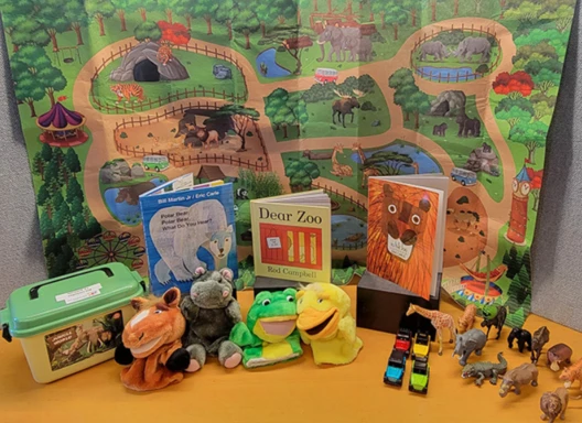 Zoo storytime kit featuring books, animal puppets and figurines.