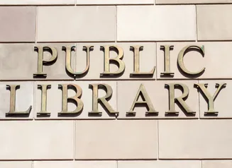 "Public Library" sign on the exterior of a building.