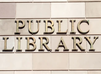 "Public Library" sign on the exterior of a building.