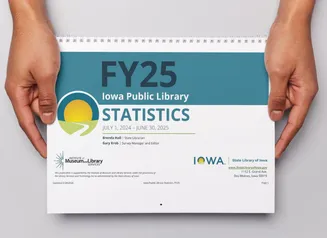 Hands holding a printed copy of the Public Library Annual Statistics publication.